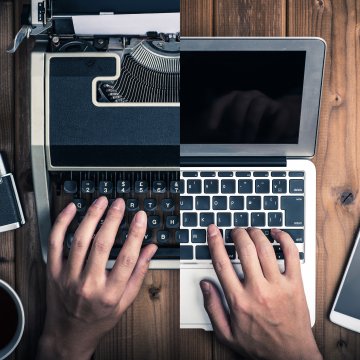 Half screen of laptop and the other half a typewriter 